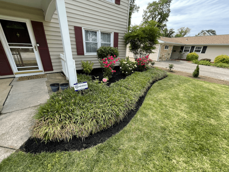 Front landscaping bed with flowers and fresh edging
